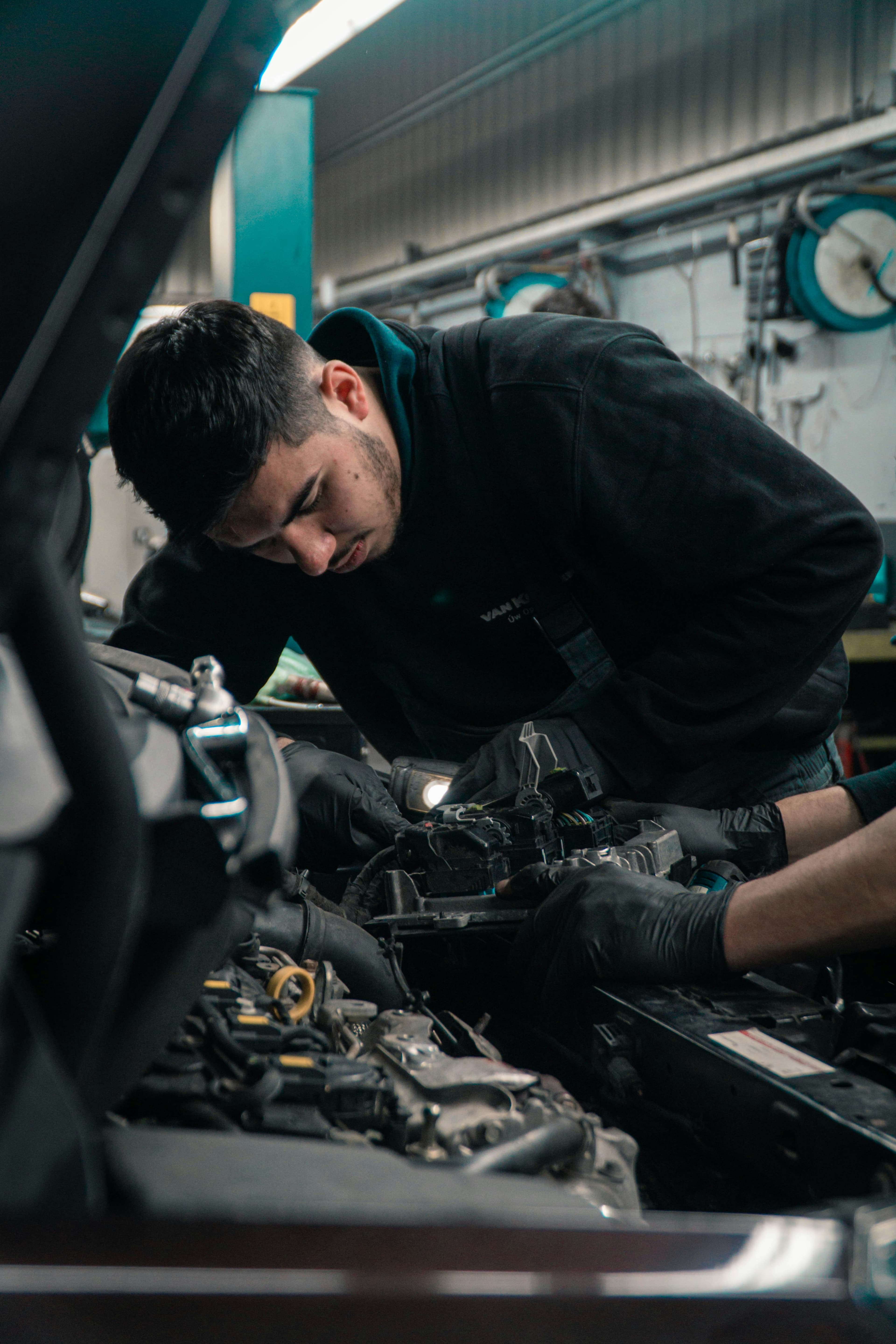 Mechanic diagnosing a car engine on-site