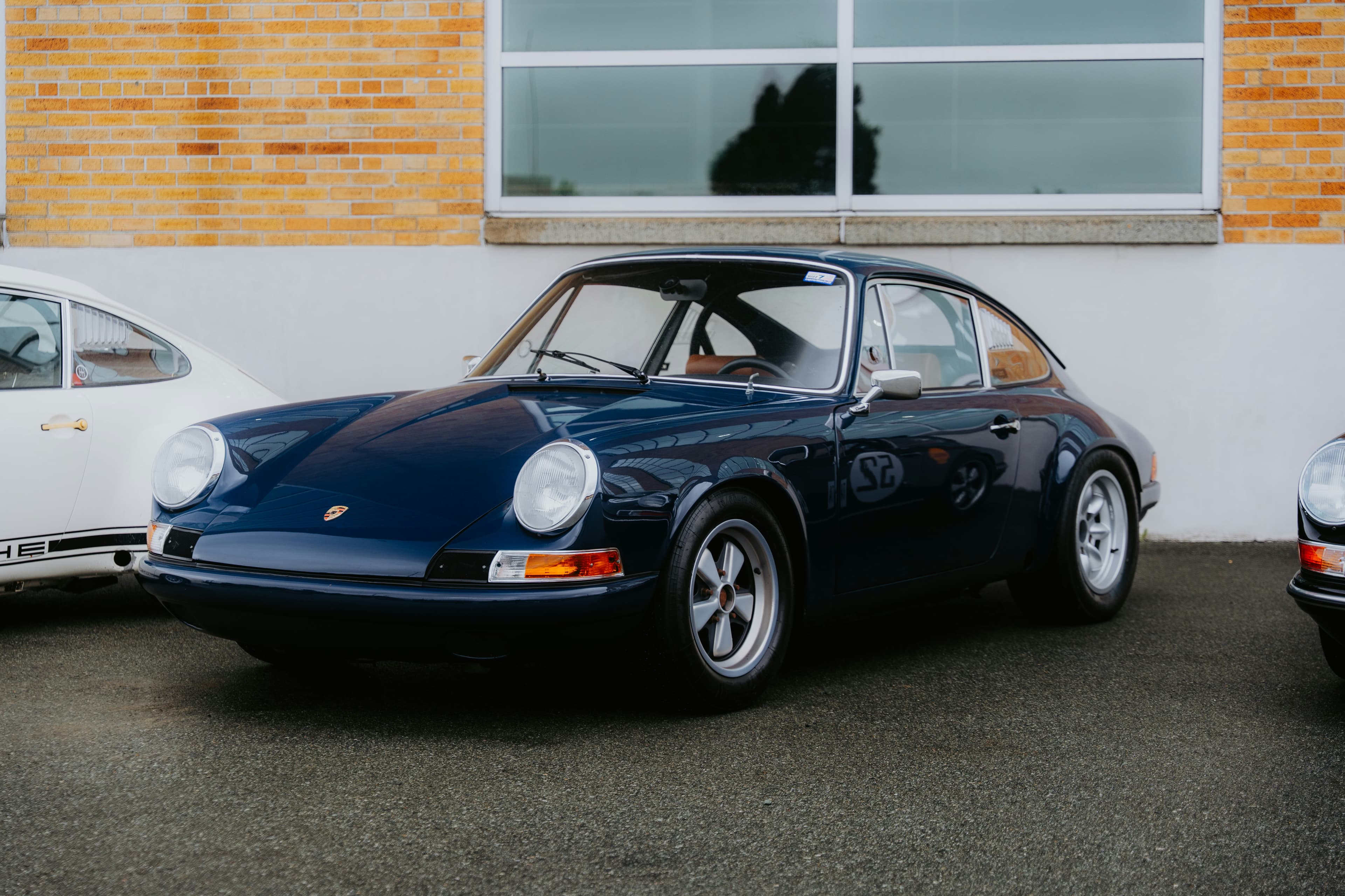 Classic blue early Porsche 911 parked outside